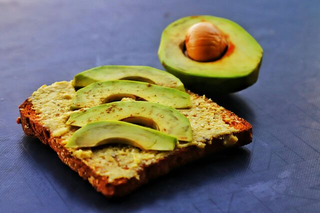 a piece of bread with avocado on top of it